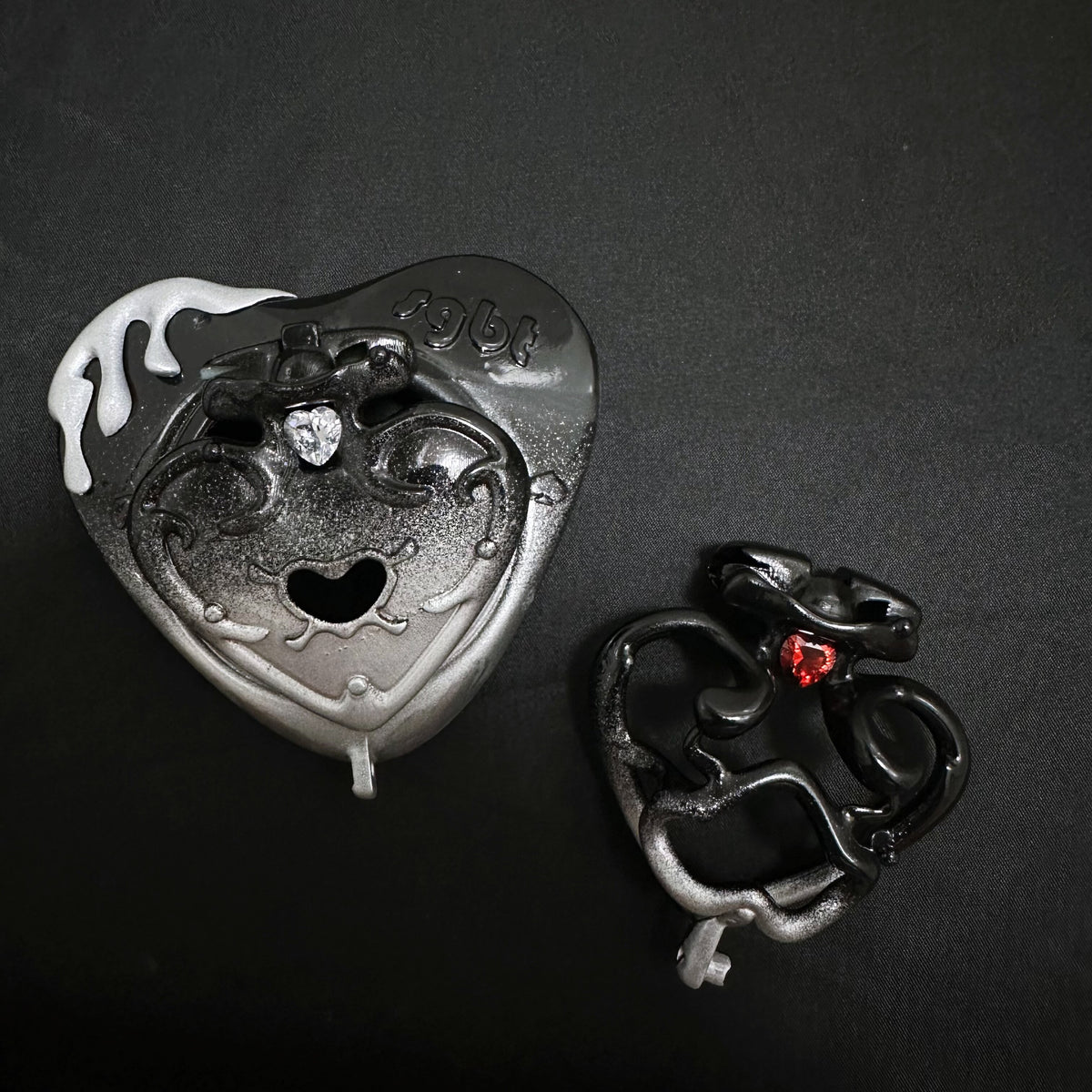 Actual Black Spade resin product photograph showing textured dark finish and clear and red gem accents