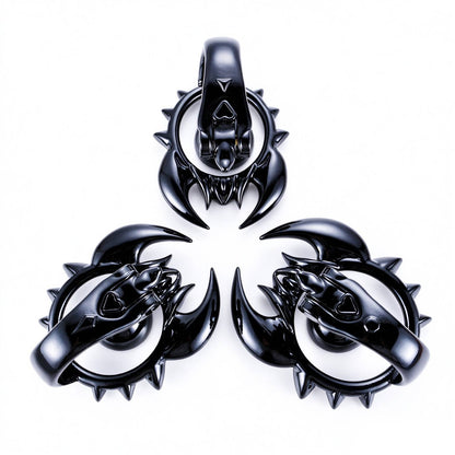 Black scorpion chastity cage front and side angles on white background
