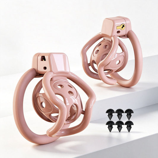 Pink spider-frame plastic chastity cage shown from front and side with removable silicone studs